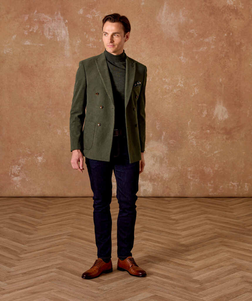 Man is wearing a double-breasted jacket paired with turtleneck jumper